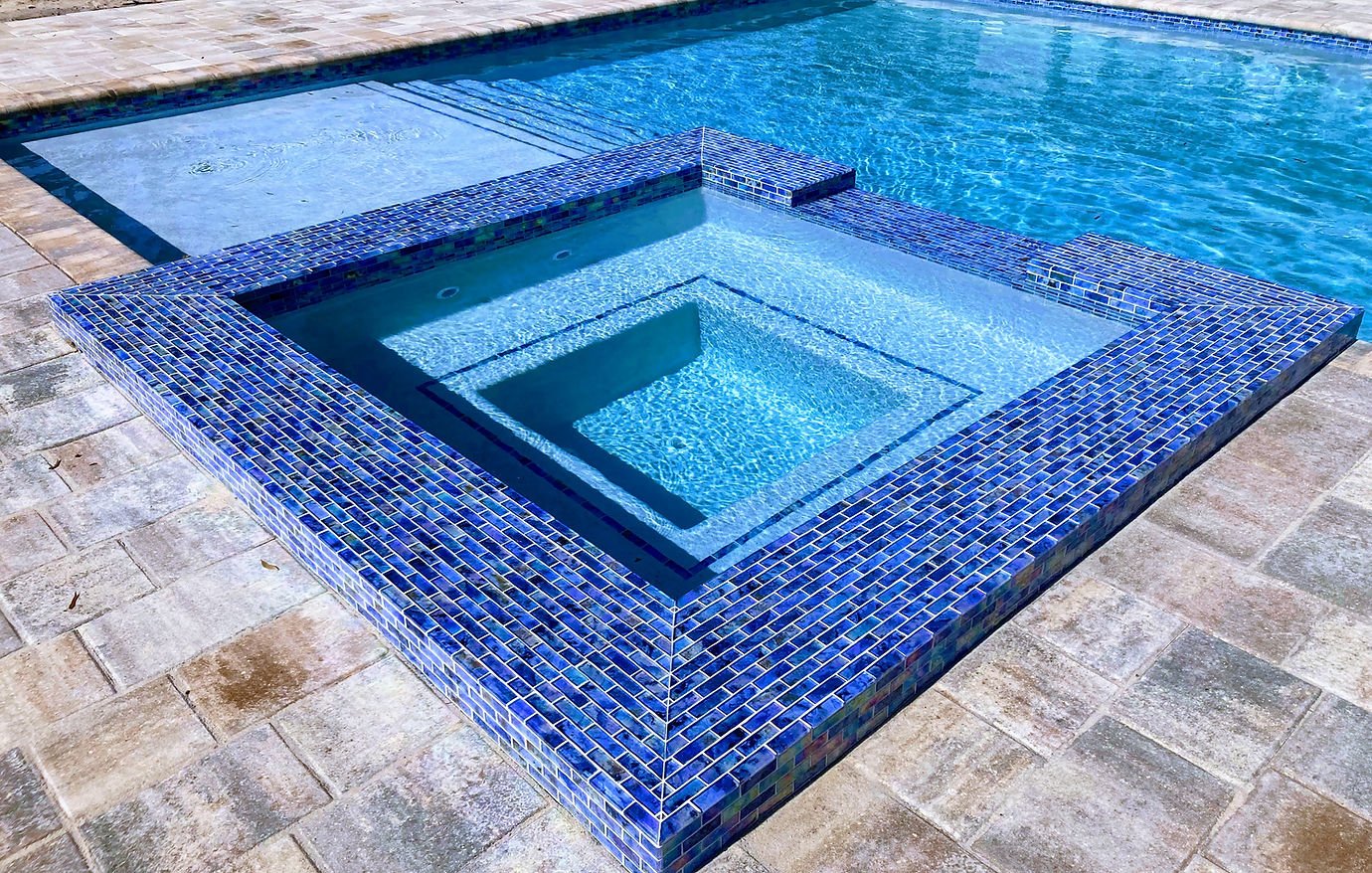 Glass-mosaic raised spa with spillover